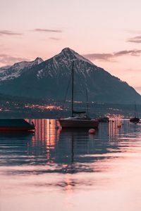 Sailboats on lake during sunset