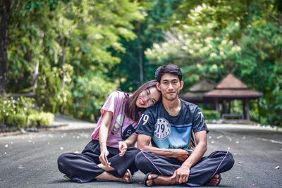 Portrait of young couple sitting outdoors