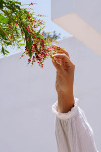 Woman smiling touching the berries on the tree