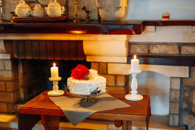 Close-up of illuminated candles on table