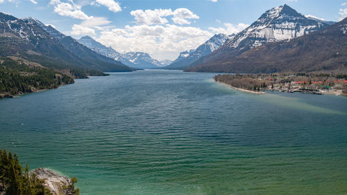 Scenic view of sea and mountains against sky