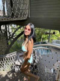 Portrait of young woman standing in city