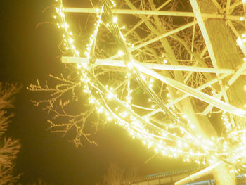 Low angle view of illuminated lights at night