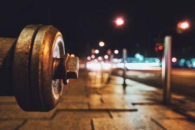 Close-up of illuminated glass on table at night