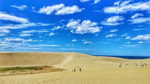 Scenic view of sand dune against sky