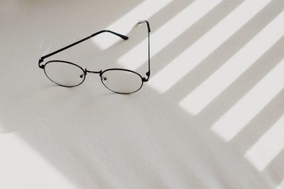 High angle view of eyeglasses on table against wall