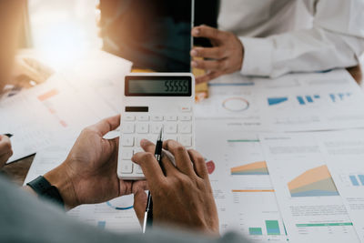 Midsection of business people working at office