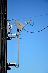 Low angle view of street light against blue sky