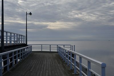 Pier over sea against sky