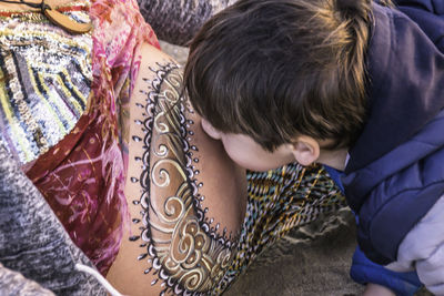 Close-up of boy kissing pregnant mother