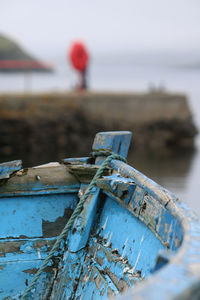 Close-up of abandoned boat in harbour 