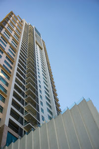 Low angle view of modern building against clear blue sky