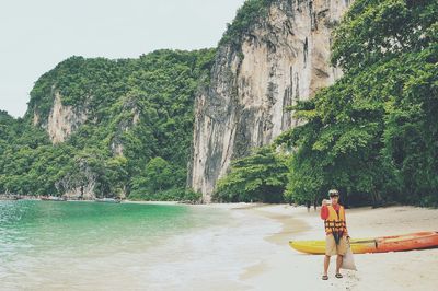 Full length of woman standing on cliff