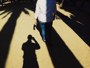 Shadow of people on road