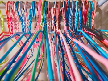 Full frame shot of multi colored clothhangers on rack