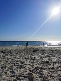 Scenic view of sea against clear sky on sunny day