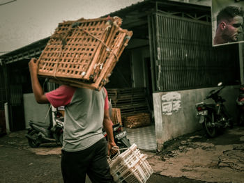 Rear view of people working on street