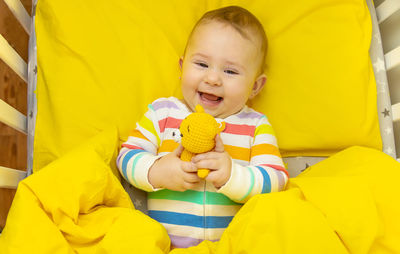 Portrait of cute baby boy sleeping on bed at home