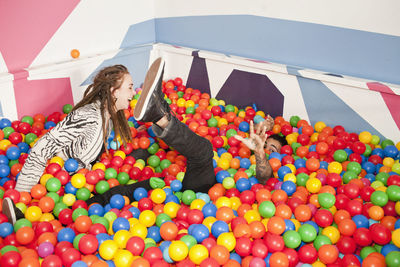 Friends playing in a ball pit