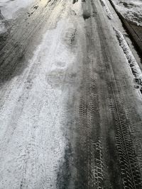 Tire tracks on snow covered road