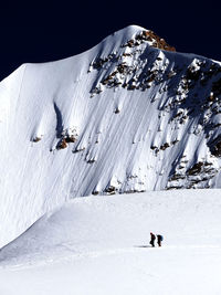 People skiing on snow covered mountain