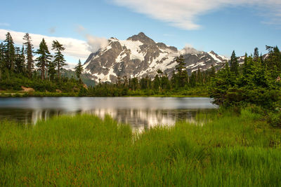 Scenic view of lake and mountains against sky