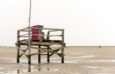 Lifeguard hut on beach against clear sky