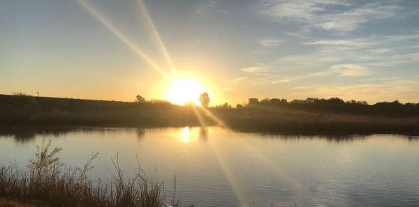 Scenic view of lake against sky during sunset