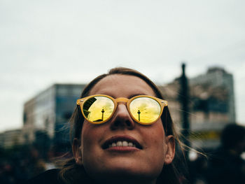 Close-up portrait of man wearing sunglasses against sky