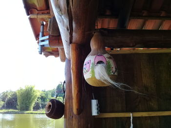 Low angle view of girl hanging from roof