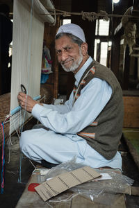 Portrait of a man sitting on floor