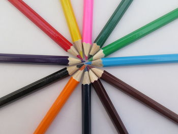 High angle view of multi colored pencils on white table