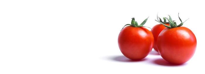 Close-up of tomatoes against white background