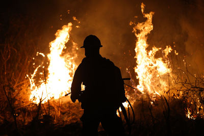 Silhouette of bonfire at night