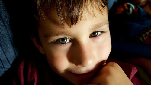 Close-up portrait of cute boy at home