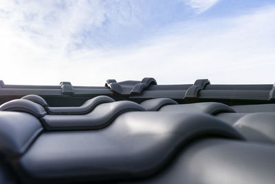 Ridge tile on the roof of a single-family house covered with a new ceramic tile in anthracite