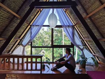 People sitting on table by window at home