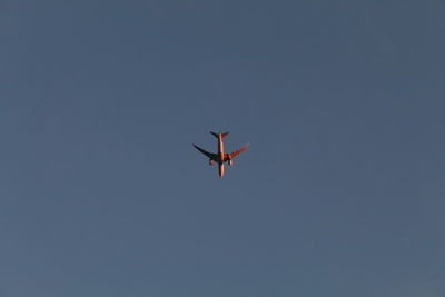 Low angle view of airplane against clear sky