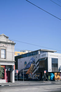 Vehicles on road against clear blue sky