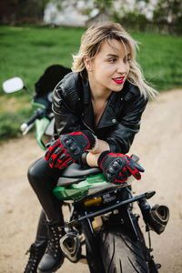 Young woman riding bicycle on field