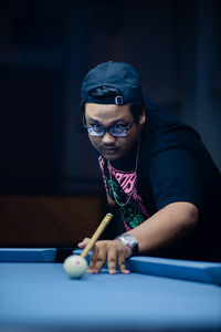 Young woman playing pool