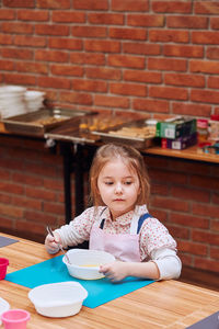 Girl sitting on table