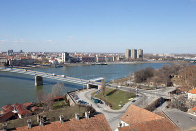 High angle view of buildings by river against sky