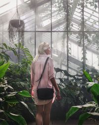 Woman standing in greenhouse