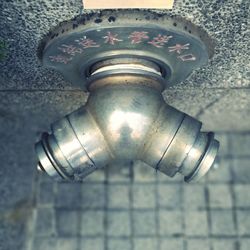 Low angle view of old electric light on wall