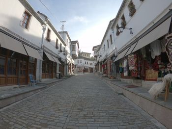 Street amidst buildings in city against sky