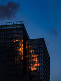 Low angle view of illuminated fire against sky at dusk