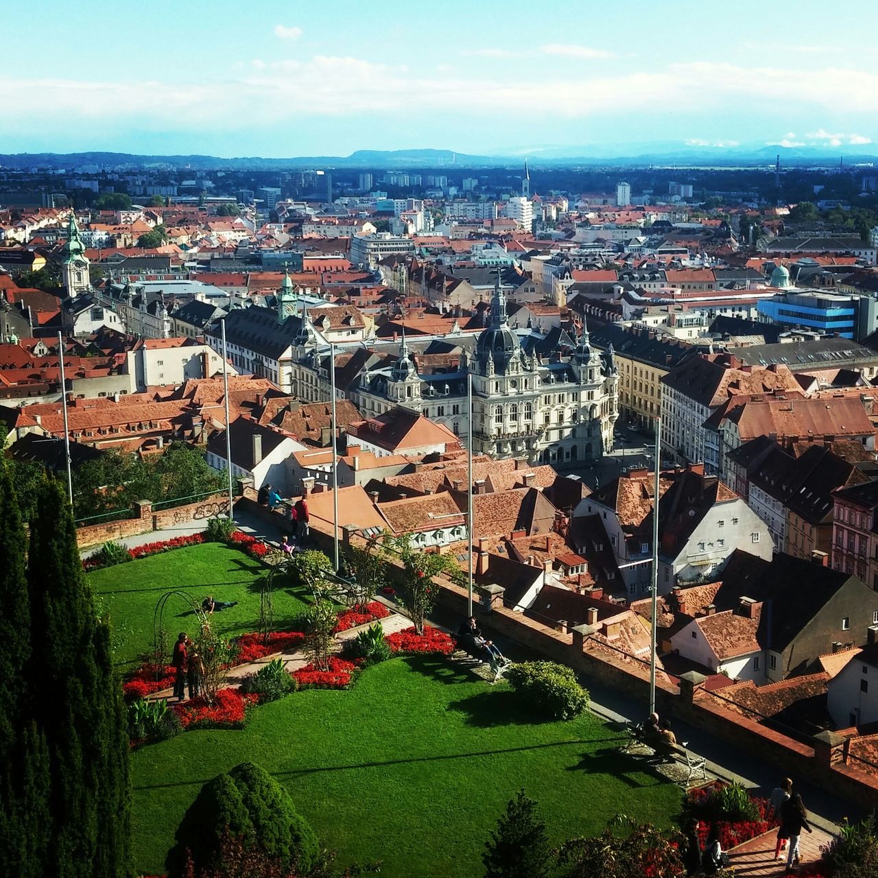 architecture, building exterior, built structure, cityscape, city, high angle view, crowded, sky, residential district, tree, residential building, river, residential structure, city life, landscape, cloud - sky, outdoors, day, townscape, town