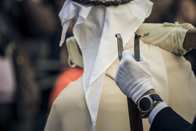 Rear view of man holding white umbrella