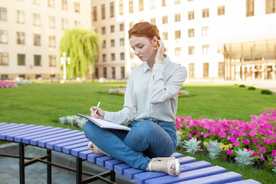 Woman holding book in campus